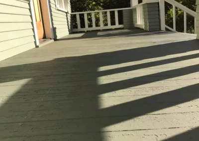 Deck painting and staining service Redmond WA — freshly refinished gray-green wood deck planks