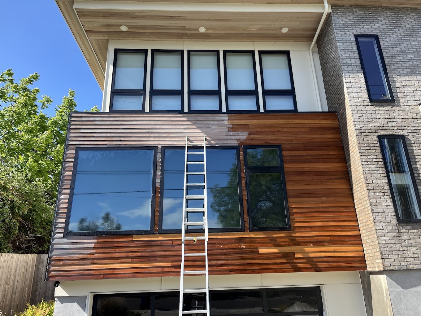 Exterior staining Redmond WA — modern home with horizontal wood-slat siding being restained