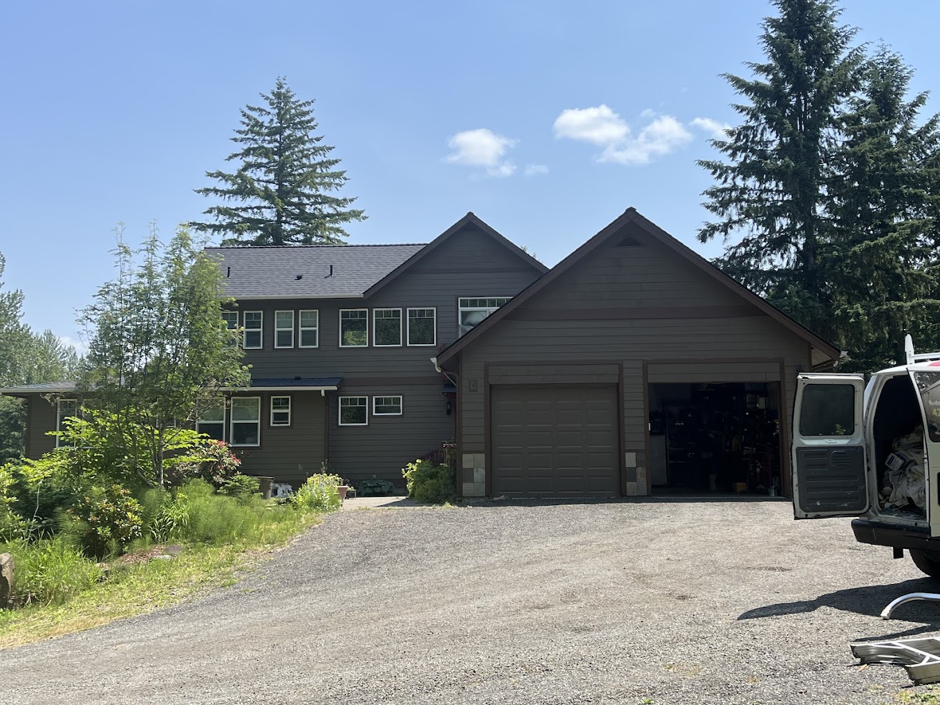 Exterior house painting Redmond WA — olive-brown two-story home with Redmond Pro Painting work van in driveway