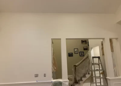 Interior painting Redmond WA — stairwell and foyer with crisp white walls and trim