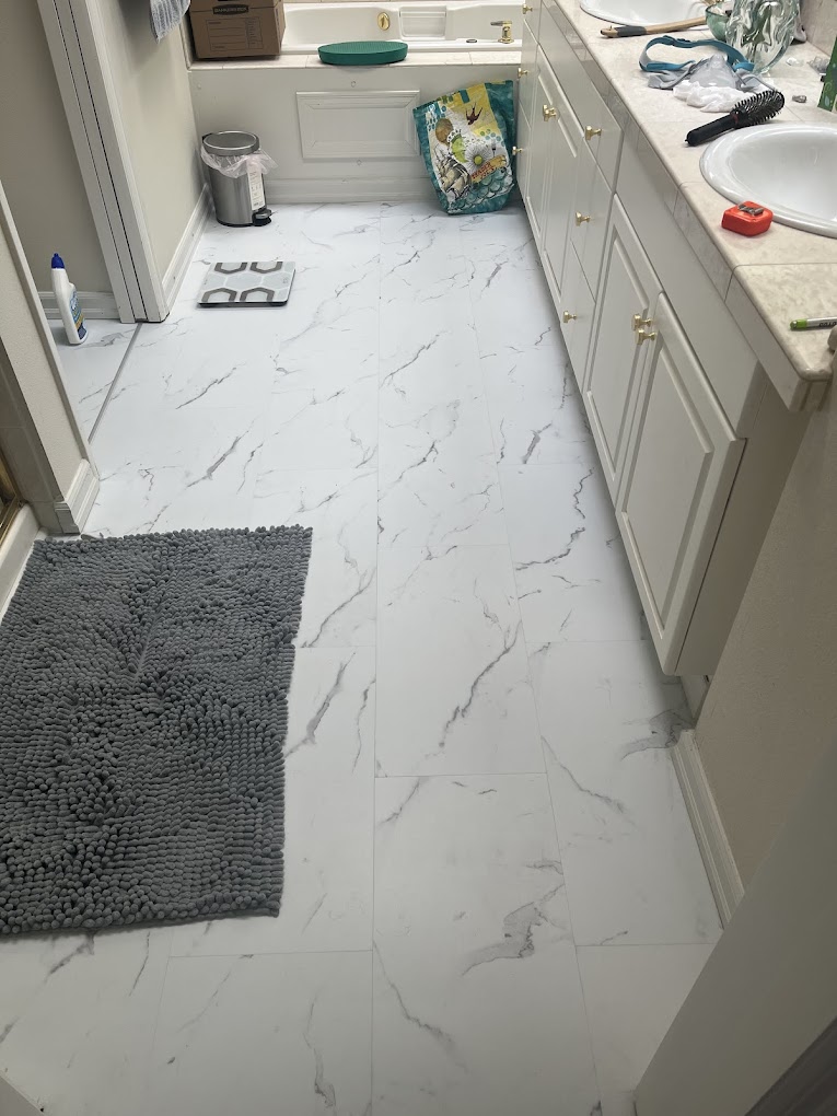 Flooring installation Redmond WA — marble-look tile flooring in a clean white bathroom