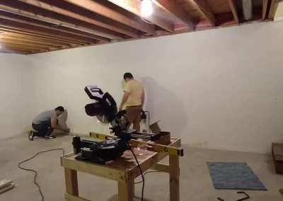 Remodeling services Redmond WA — crew working with miter saw on basement remodel