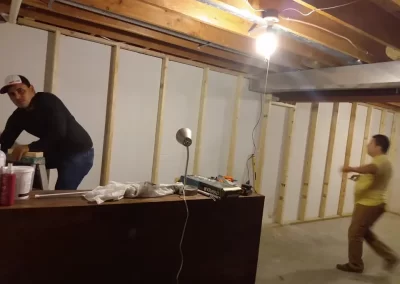 Home remodeling contractor Redmond WA — crew framing and prepping basement remodel