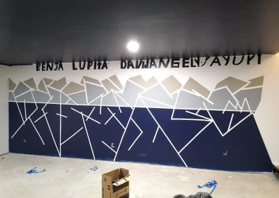 Wall design painting Redmond WA — geometric blue and gray accent wall in progress