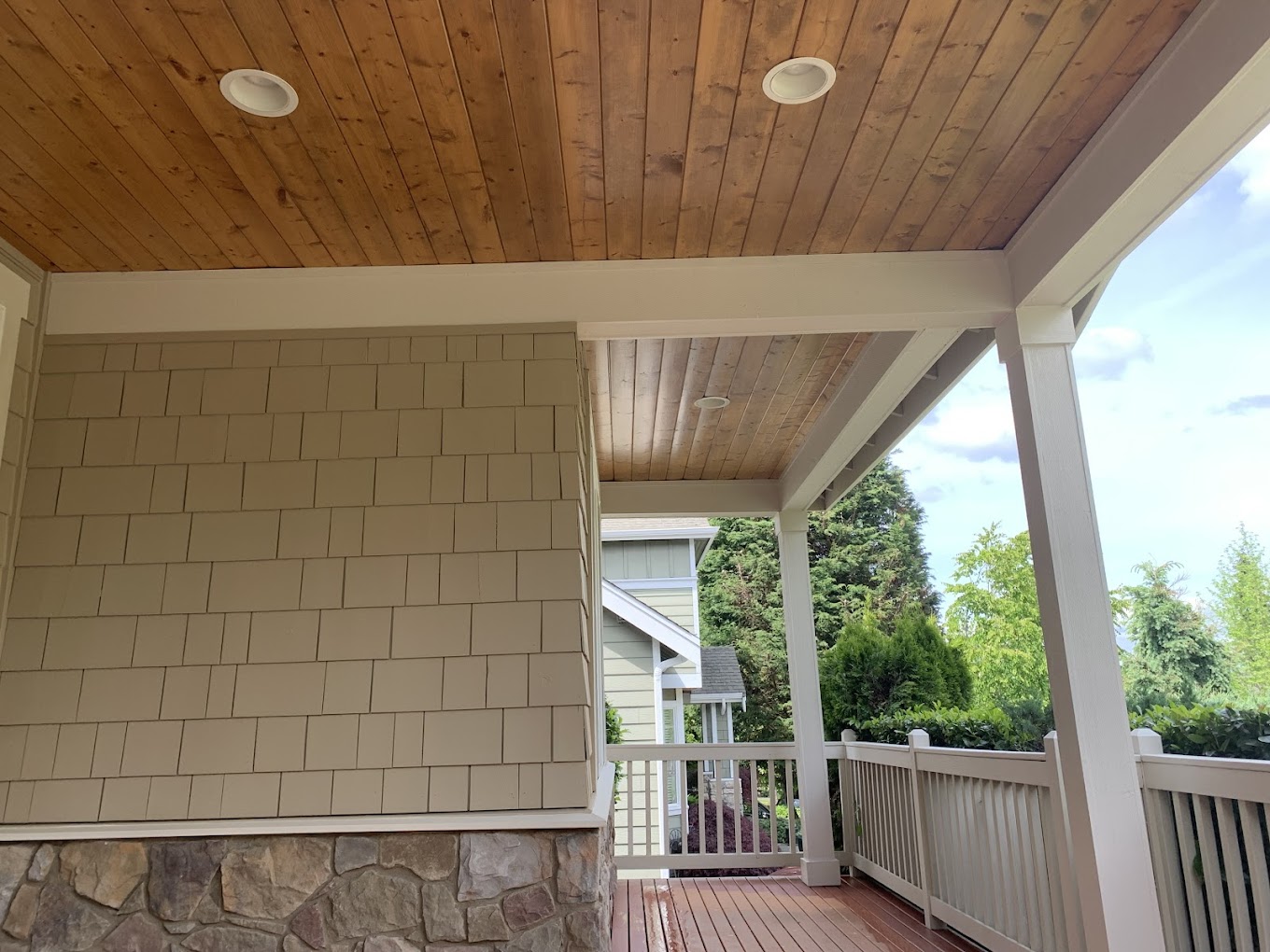 Wood ceiling varnish Redmond WA — natural cedar tongue-and-groove craftsman porch ceiling with sage shake siding
